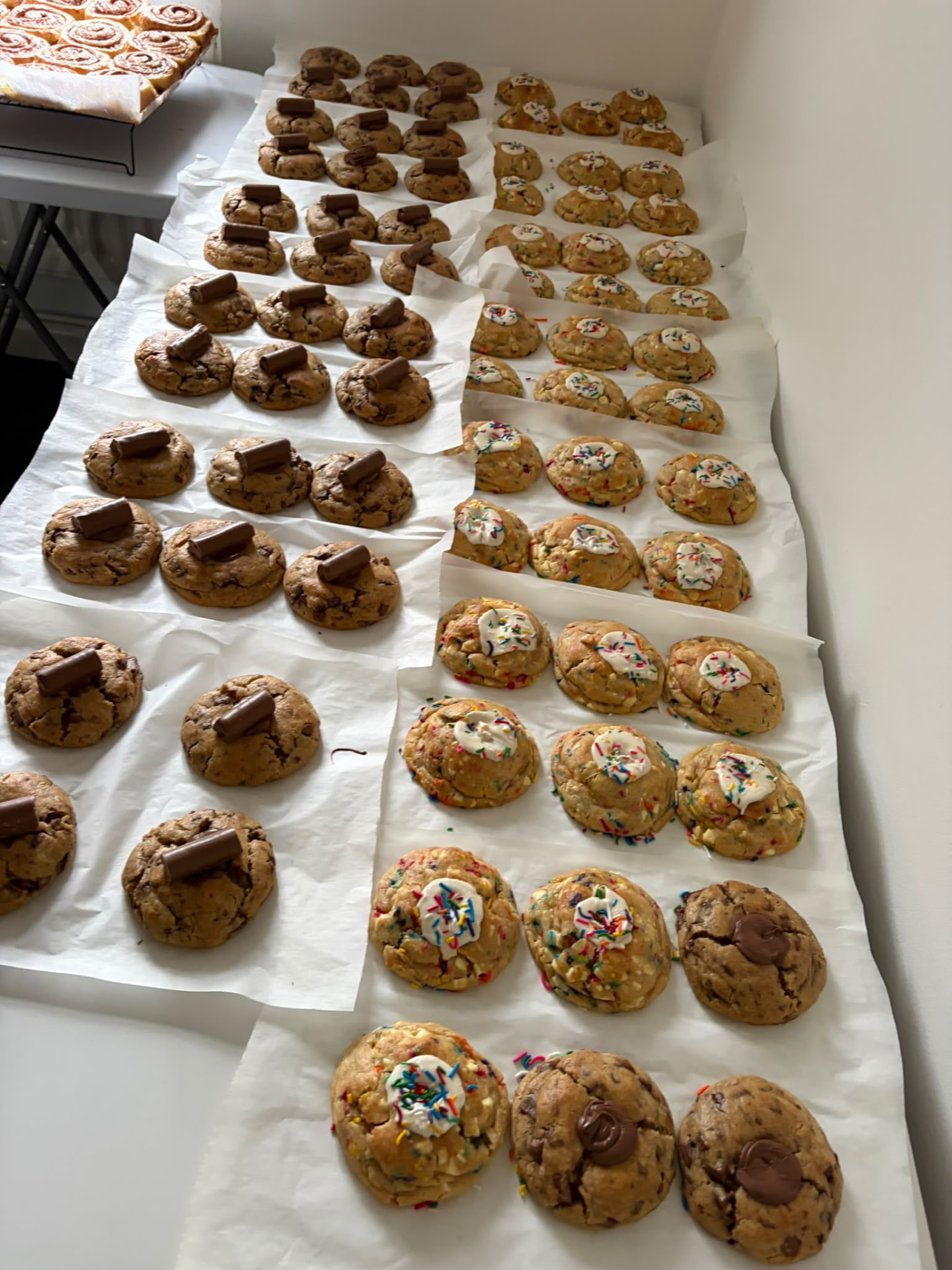 Long table of freshly baked cookies being prepped for the Cake Shed
