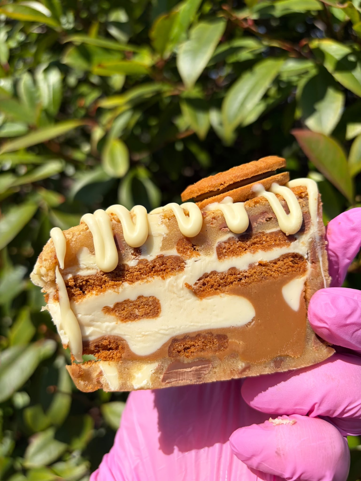 Slice of Biscoff cookie pie with white chocolate drizzle