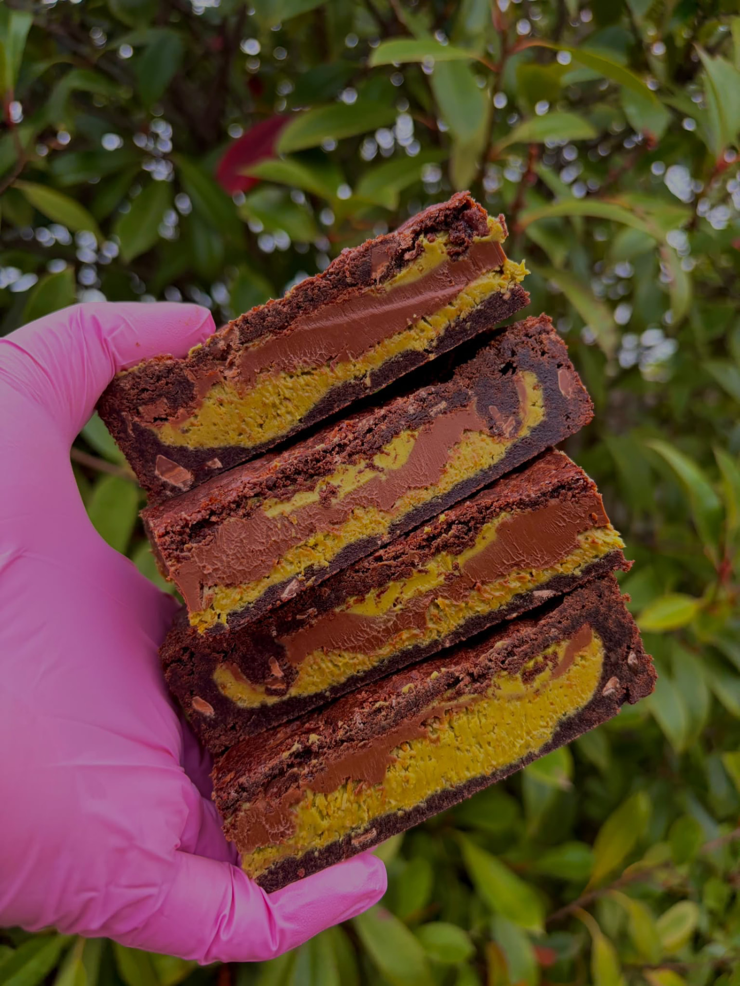 Stack of Dubai chocolate brownies with pistachio filling